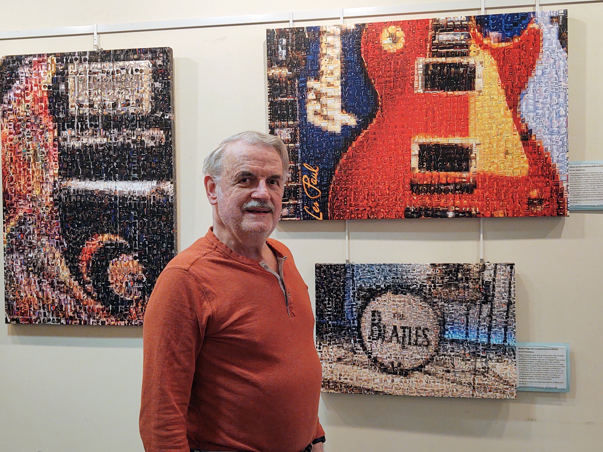 Photo of artist in front of 3 of his pieces