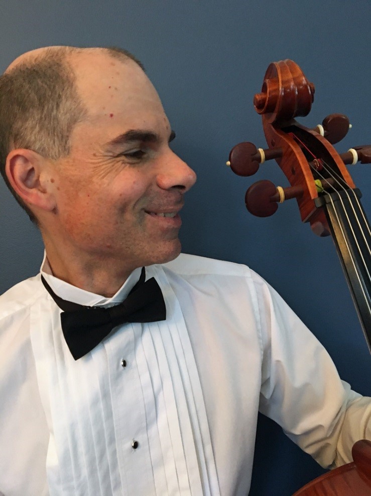 A photo of the presenter in profile holding his cello